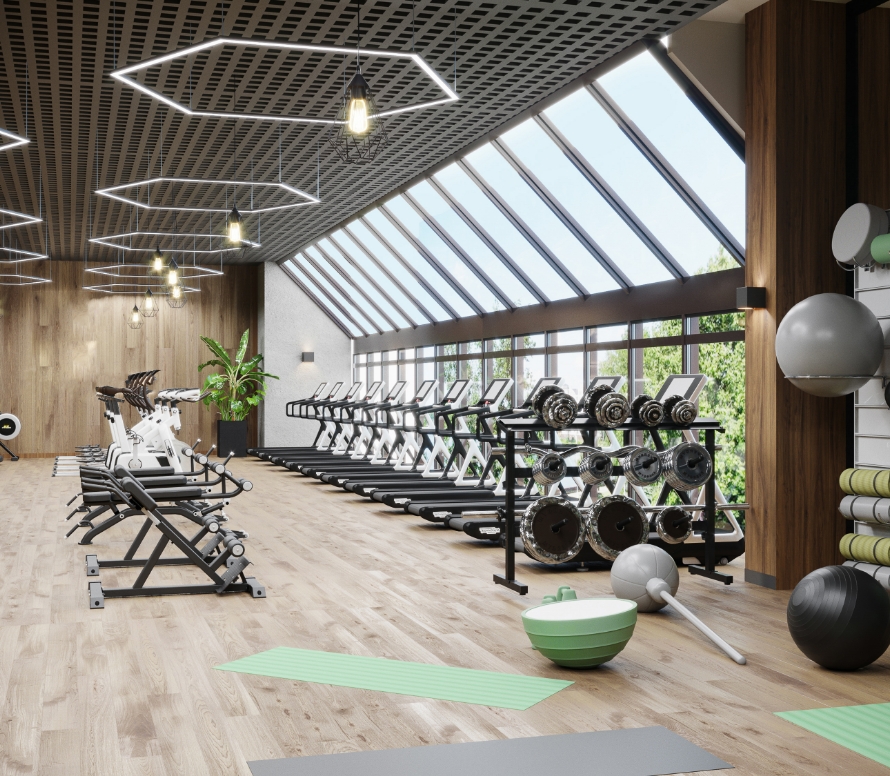 Small moden gym with rows of tredmills at the front with the windows, and behind is several bikes, ellipticals, rowing, and ab machines