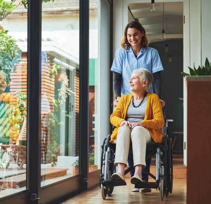 Nurse pushes senior lady on wheelchair