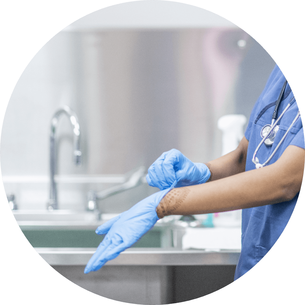 Medical Facility Cleaning by an employee wearing scrubs and blue latex gloves
