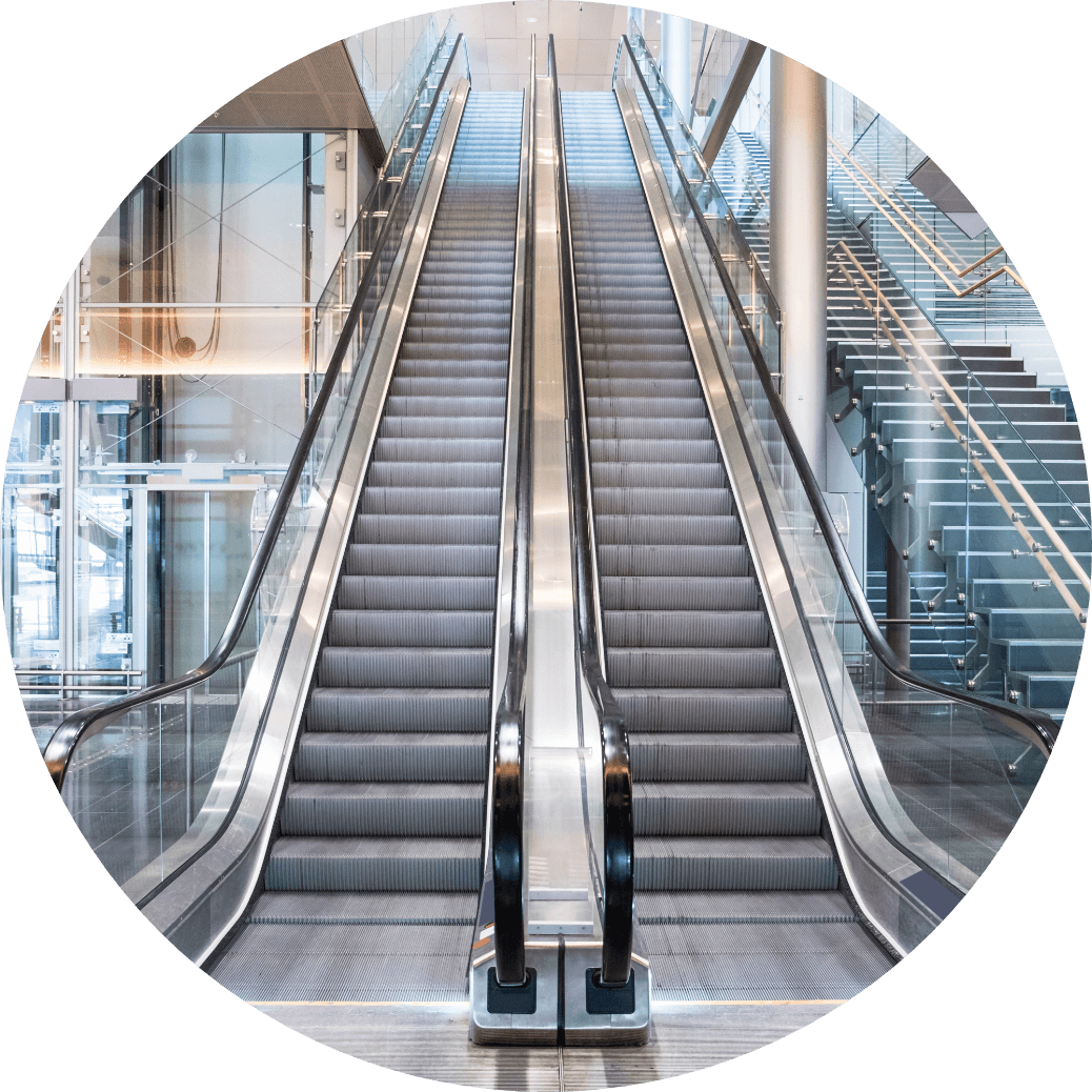 A image of an escalator with stairs off to the right