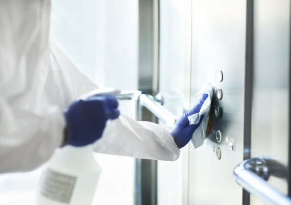 Disinfecting elevator buttons with spray