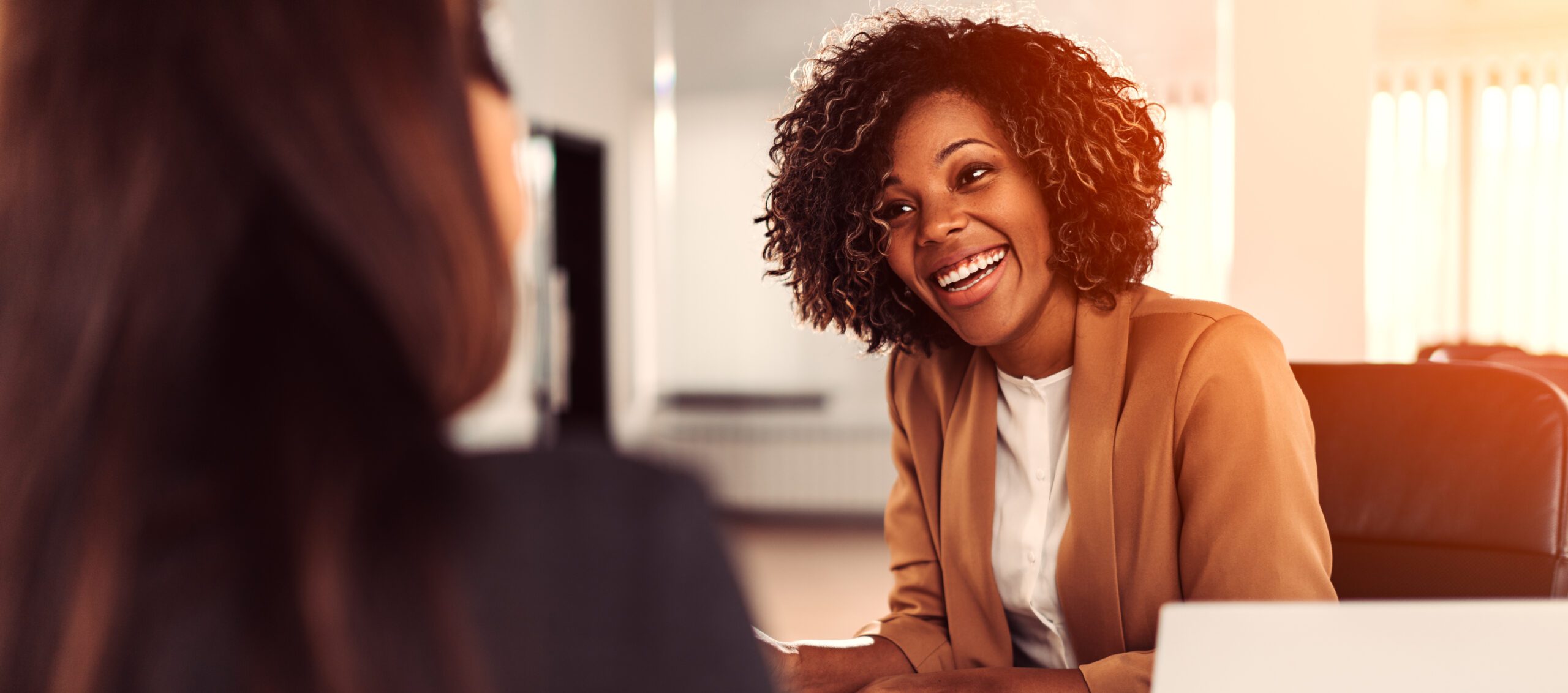 Happy young business woman at the meeting.